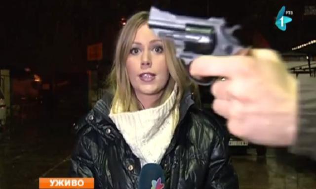 Man "waves gun" in front of reporter during live broadcast