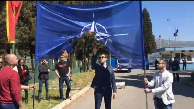 Montenegrin activist burns NATO flag before going to jail