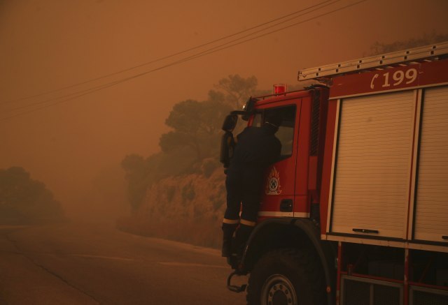 At least 74 dead as wildfires rage near Athens