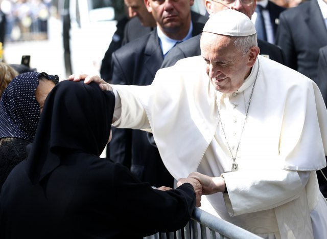 Pope to refugees: You bear cross of humanity